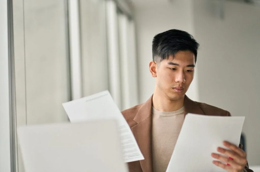 Man reading his credit card processing statement